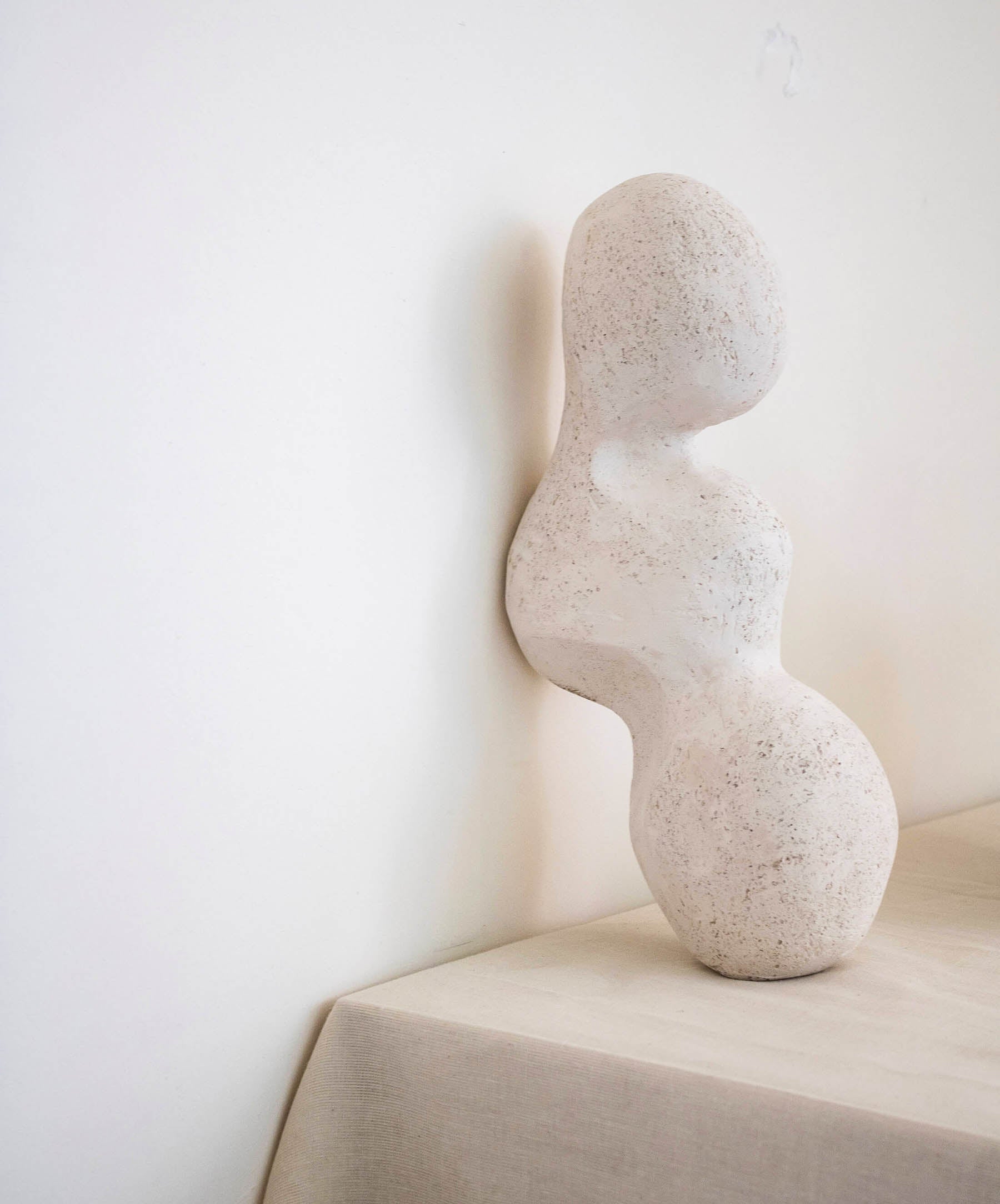 Abstract stone sculpture on a neutral background
